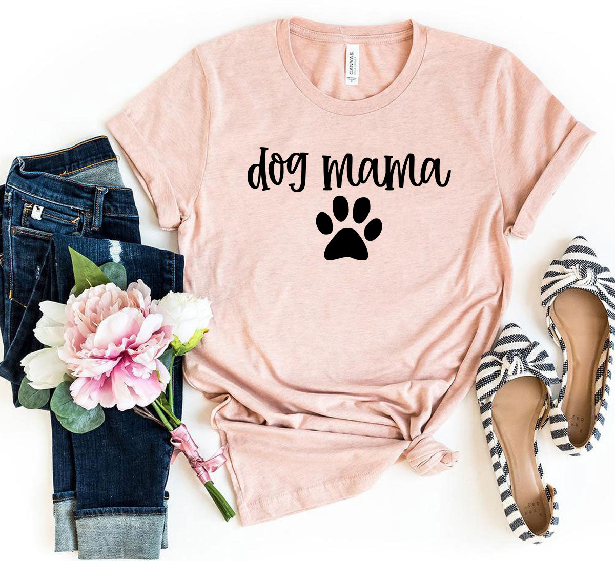 Celebrate your love for your furry family with our Dog Mama T-Shirt! Featuring the words “Dog Mama” in charming script and accented with an adorable paw print, this tee is perfect for pet moms who wear their love proudly. Made from soft, premium fabric, it’s designed for all-day comfort whether you're out with your pup, lounging at home, or meeting other dog lovers.