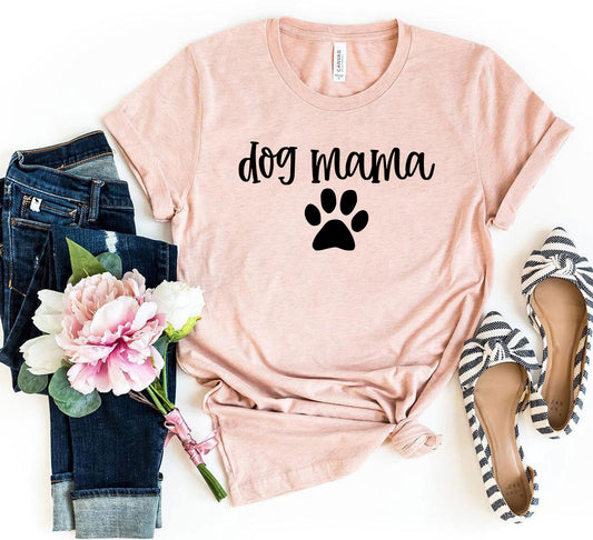Celebrate your love for your furry family with our Dog Mama T-Shirt! Featuring the words “Dog Mama” in charming script and accented with an adorable paw print, this tee is perfect for pet moms who wear their love proudly. Made from soft, premium fabric, it’s designed for all-day comfort whether you're out with your pup, lounging at home, or meeting other dog lovers.